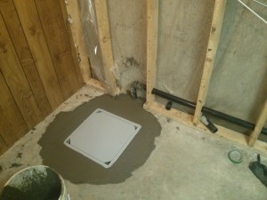 sump pump installation - sump pump repair - sump hole is filled with cement and sump pump installed.